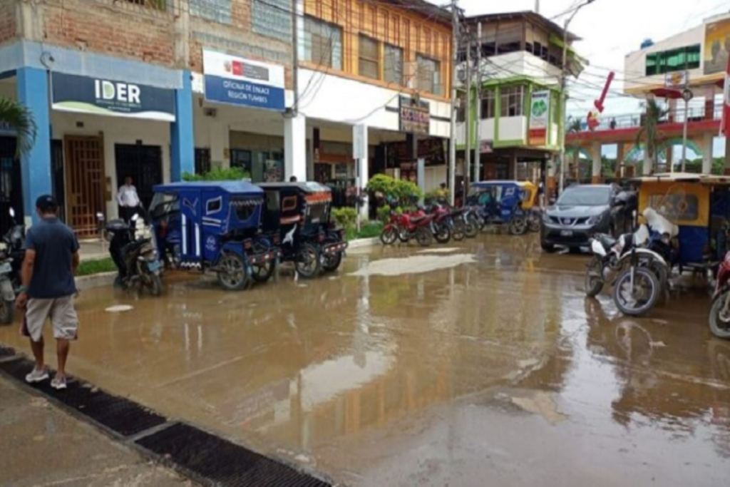 Una persona cruza la calle inundada de agua de Lluvia en Piura. 