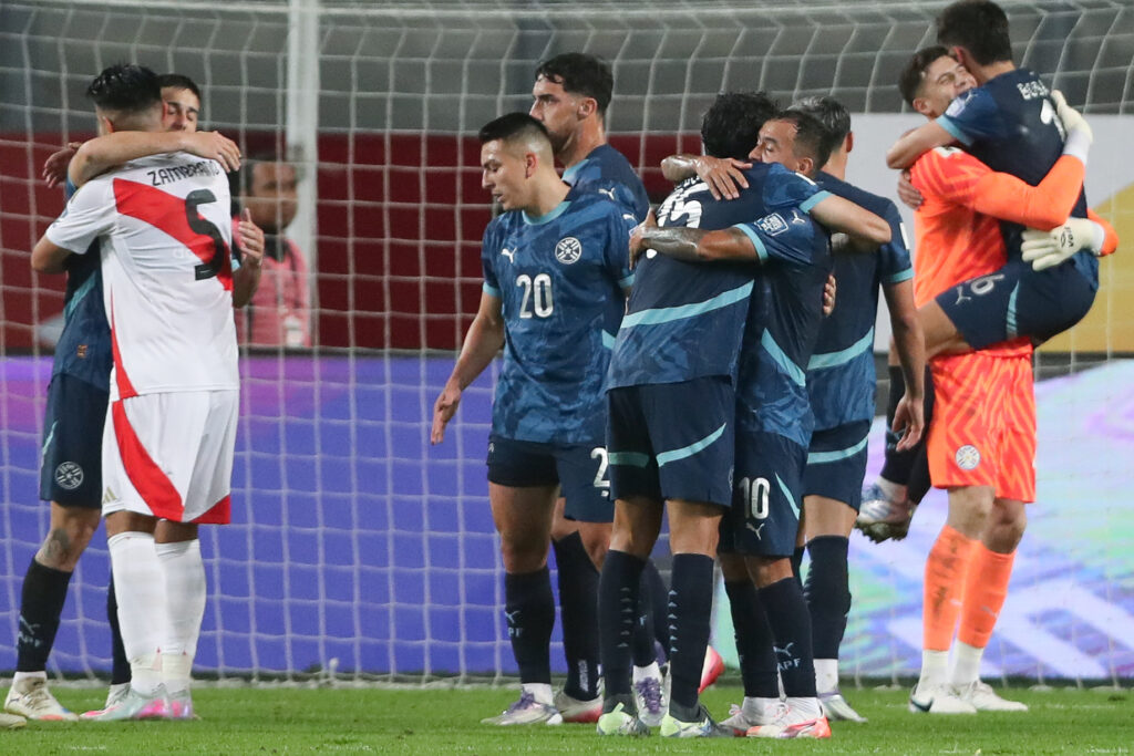 Carlos Zambrano, defensa de Perú, se abraza con un jugador paraguayo tras el partido por las Eliminatorias. 